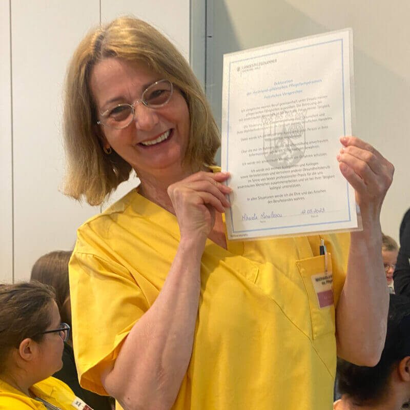 Stolze Mitarbeiterin mit Urkunde